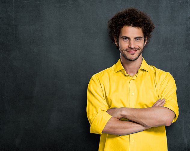 Relaxed man in yellow shirt because he just found Electrical Engineering Jobs